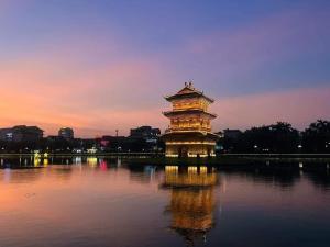 a large tower in the middle of a lake at Bich Gian Trang An Hostel in Nguyên Ngoại