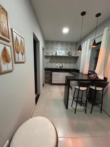a kitchen with a table and chairs in a room at Pousada Aconchego Mineiro in Aracaju +11 photos