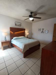 a bedroom with a bed and a ceiling fan at Villa Serena Erizos 2 in San Carlos +23 photos