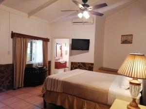 a bedroom with a bed and a ceiling fan at Honduyate in Las Marías