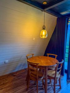 a dining room table with chairs and a light fixture at A frame Riverston in Matale