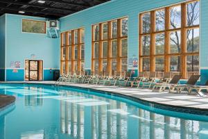 a swimming pool with chairs in a building at Timberline Hideaway with Hot Tub in Hollister +48 photos