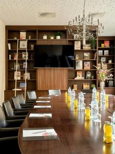 a conference room with a long wooden table and chairs at Flemings Hotel Wien-Stadthalle in Vienna +29 photos