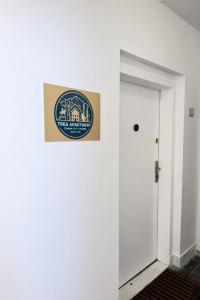 a sign on a wall next to a door at Trea Apartment in Tirana