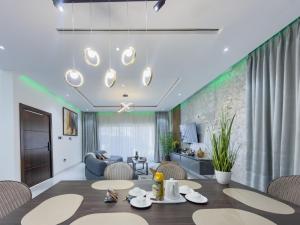 a dining room with a table and chairs and a couch at Luxury Villa at THE HIDDEN DOMUS I Trassaco, East Legon in Accra