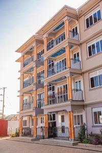 a large building with balconies on the side of it at Alma Hotels Kampala in Kampala