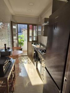 a kitchen with a large stainless steel refrigerator at CaSa FAMILY HOUSE in Casablanca