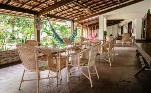 a restaurant with tables and chairs in a room at Pousada da Mércia - Itapuã (BA) in Salvador