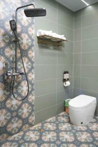 a bathroom with a shower and a toilet at Bao Di East Coast in Honghai