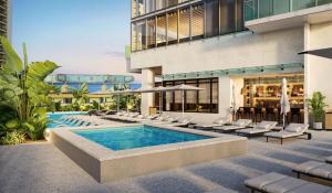 an exterior view of a building with a pool and lounge chairs at Hilton Club Ka Haku Honolulu in Honolulu