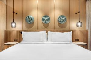 a bedroom with a white bed and two tables at Hilton Club Ka Haku Honolulu in Honolulu