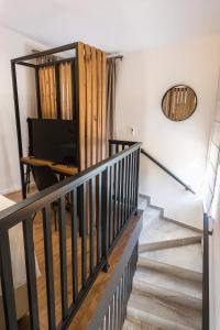 a staircase in a house with a mirror on the wall at The Hill Aparthotel in Mostar