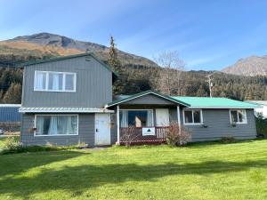 a house with a green roof on a grass field at Halibut House Unit 2 in Seward