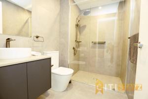 a bathroom with a shower and a toilet and a sink at Lovely in Lyneham - 1bd 1bth Apt in Canberra +35 photos