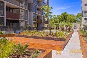 a garden in front of a building at Lovely in Lyneham - 1bd 1bth Apt in Canberra