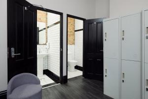 a bathroom with black doors and a toilet in it at Glebe Terraces in Sydney