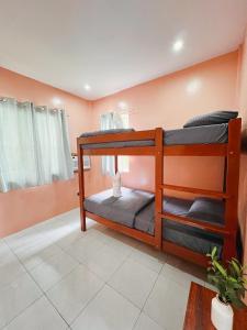 a bedroom with two bunk beds in a room at Lio house in El Nido