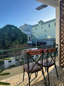 a chair sitting on a balcony with a view at Gác Homestay Phan Thiết in Ấp Sung Xuân