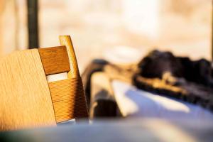 a wooden chair sitting on top of a table at Luxury Glass Tiny House and Sauna in Torrey