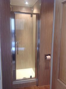 a shower with a glass door in a bathroom at The George Hotel in Montrose