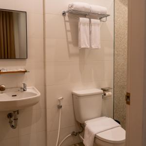 a bathroom with a toilet and a sink at Anamcara Hotel & Convention in Cipanas +5 photos