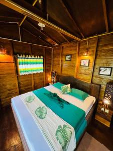a bedroom with two beds in a room with wooden walls at 360 Rainforest in Deniyaya +67 photos