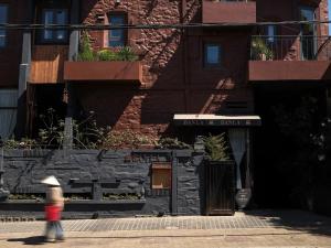 a person walking down a street in front of a building at Banla Boutique Hotel in Da Lat