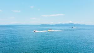 a group of people on a jet ski in the water at RIPSTICK Private Luxury Resort in Otsu +15 photos