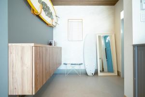 a room with a surfboard on the wall at RIPSTICK Private Luxury Resort in Otsu