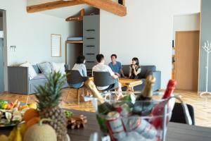 a group of people sitting in a living room at RIPSTICK Private Luxury Resort in Otsu