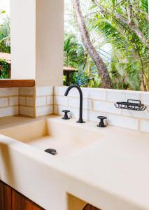 a white sink in a kitchen with a window at Villas Indigo Troncones in Troncones