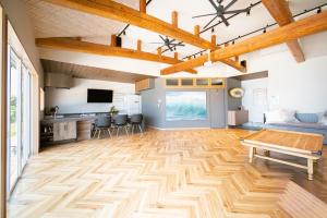 a living room with a wooden floor and a table at RIPSTICK Private Luxury Resort in Otsu