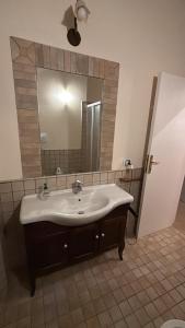 a bathroom with a sink and a large mirror at Villa Lara in Roseto degli Abruzzi