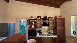a kitchen with wooden cabinets and a stove top oven at Villa Lara in Roseto degli Abruzzi +26 photos