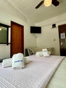 a bedroom with two beds with towels on them at Hotel Pleno Sol in Villa Gesell