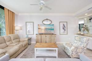 a living room with a couch and a table at Phoenix on the Bay 1129 condo in Orange Beach +39 photos