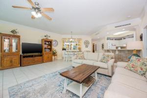 a living room with a couch and a table at Phoenix on the Bay 1415 in Orange Beach