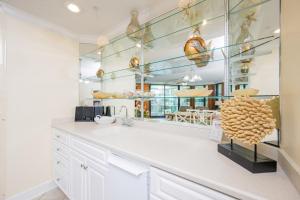 a kitchen with a sink and a mirror at Phoenix on the Bay 1415 in Orange Beach +38 photos