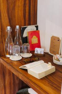 a table with an open book and glasses and bottles at Villas Indigo Troncones in Troncones +10 photos