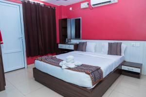 a bedroom with a large bed with a red wall at Hotel Royal Inn, Nuwakot in Trisūli Bāzār +79 photos