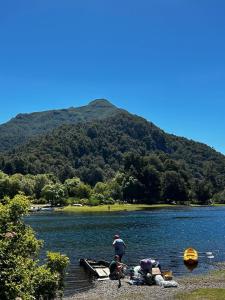 a group of people on a dock on a lake at Aromas de Montaña VIP in Junín de los Andes
