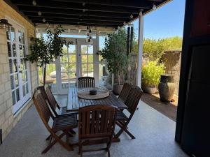a patio with a table and chairs on a porch at Beach Haven in Bunbury