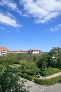a view of a park with buildings and trees at Danish style apartment in Copenhagen