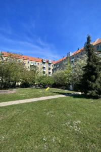 a park with a large building in the background at Danish style apartment in Copenhagen