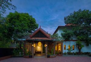a house with a lit up front yard at Green Morodoc Garden Hotel in Siem Reap
