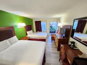a hotel room with two beds and a desk at Elk Inn Motel I-77,Exit 85 in Elkin