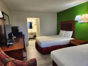 a hotel room with two beds and a television at Elk Inn Motel I-77,Exit 85 in Elkin