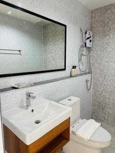 a bathroom with a sink and a mirror and a toilet at SK Residence & resort in Ban Nong Pla Mo +20 photos