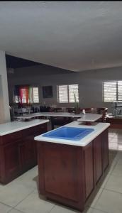 a large kitchen with a blue island in the middle at Penthouse villa 1 in Montego Bay