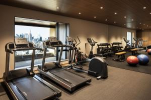 a gym with cardio equipment and a large window at THE AOYAMA GRAND HOTEL in Tokyo +62 photos